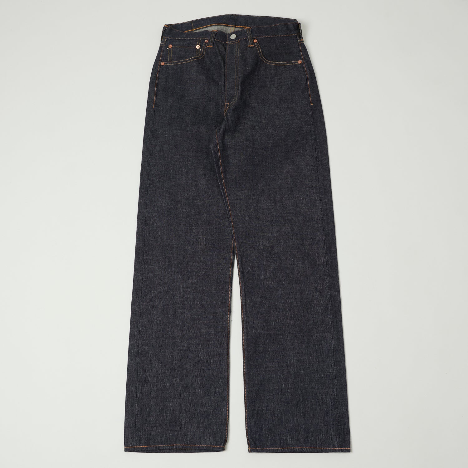 A pair of raw selvedge jeans shown flat from the front.