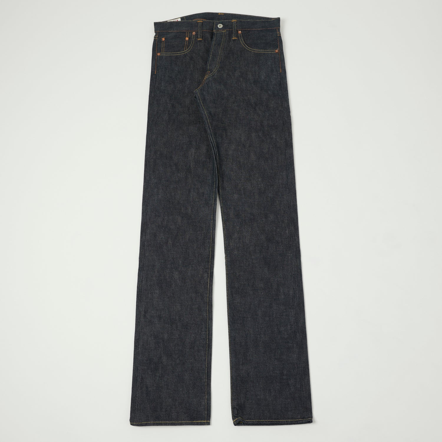 A pair of raw selvedge jeans shown flat from the front.